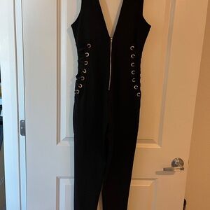 Black jumpsuit. Lots of stretch. Flattering and contouring. Measurements on pics
